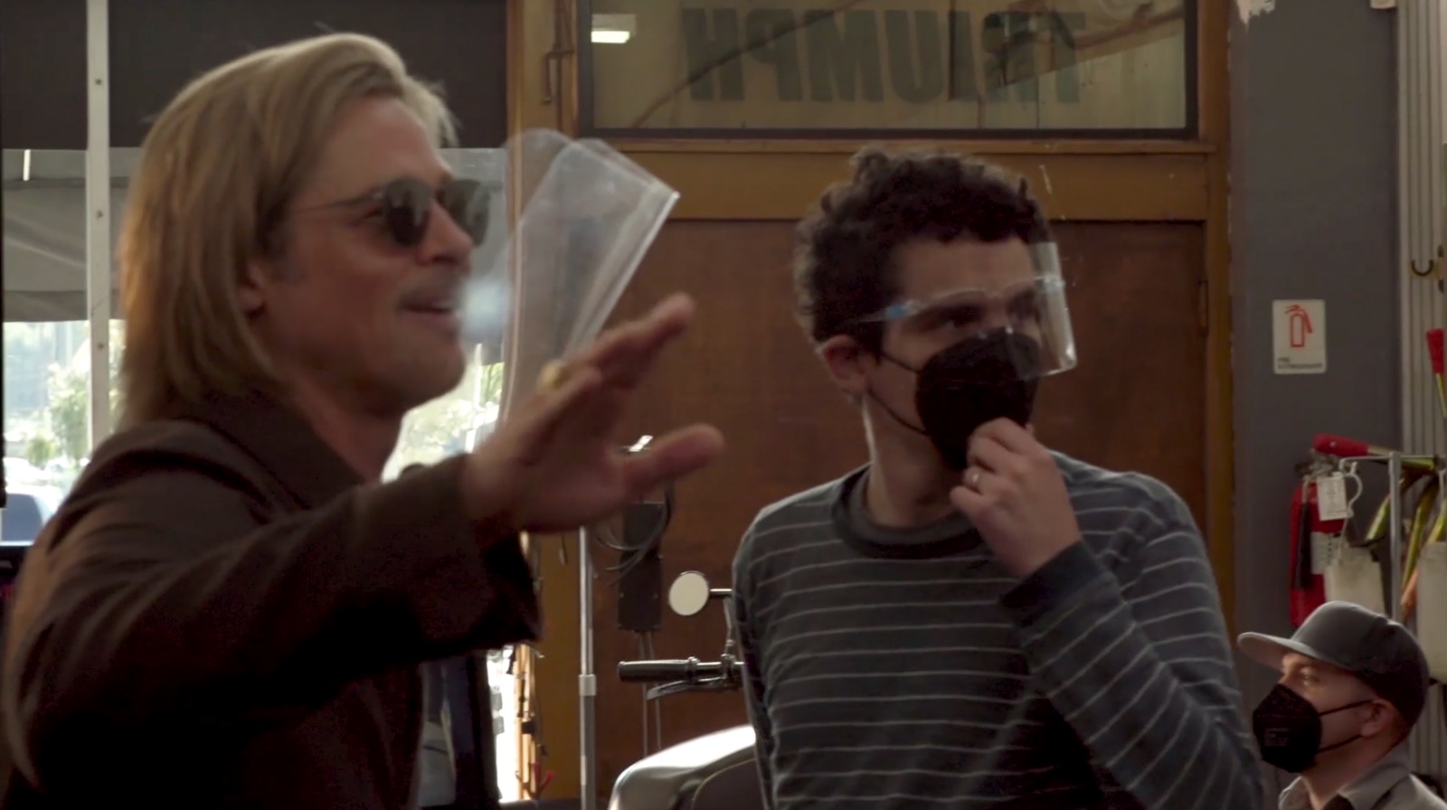Damien Chazelle directing Brad Pitt on set