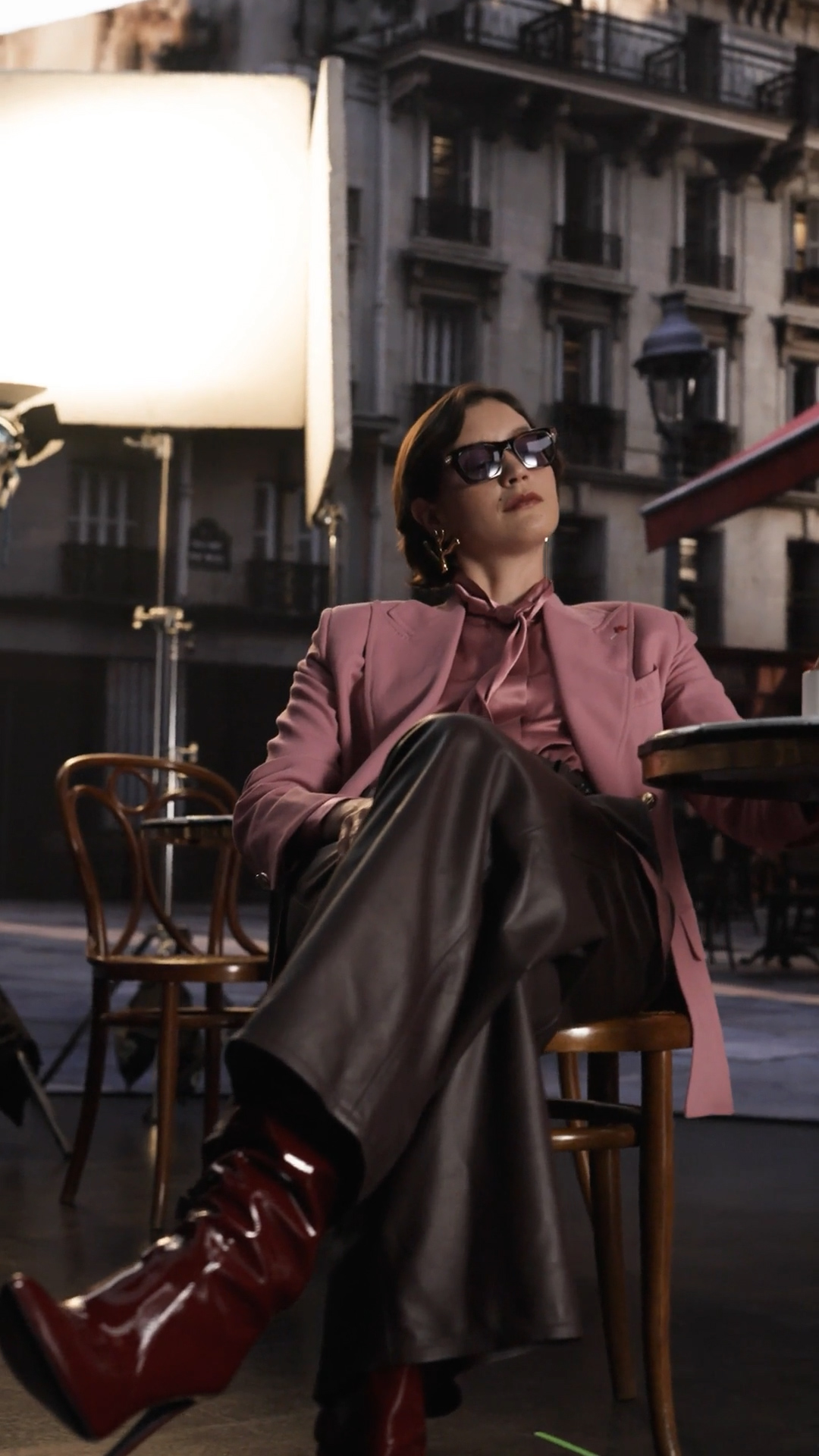 On set — actress in pink between takes